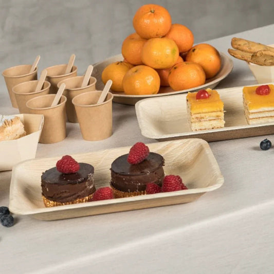Prato Retangular Largo de Folha de Palmeira com sobremesas e frutas, ideal para catering e eventos.